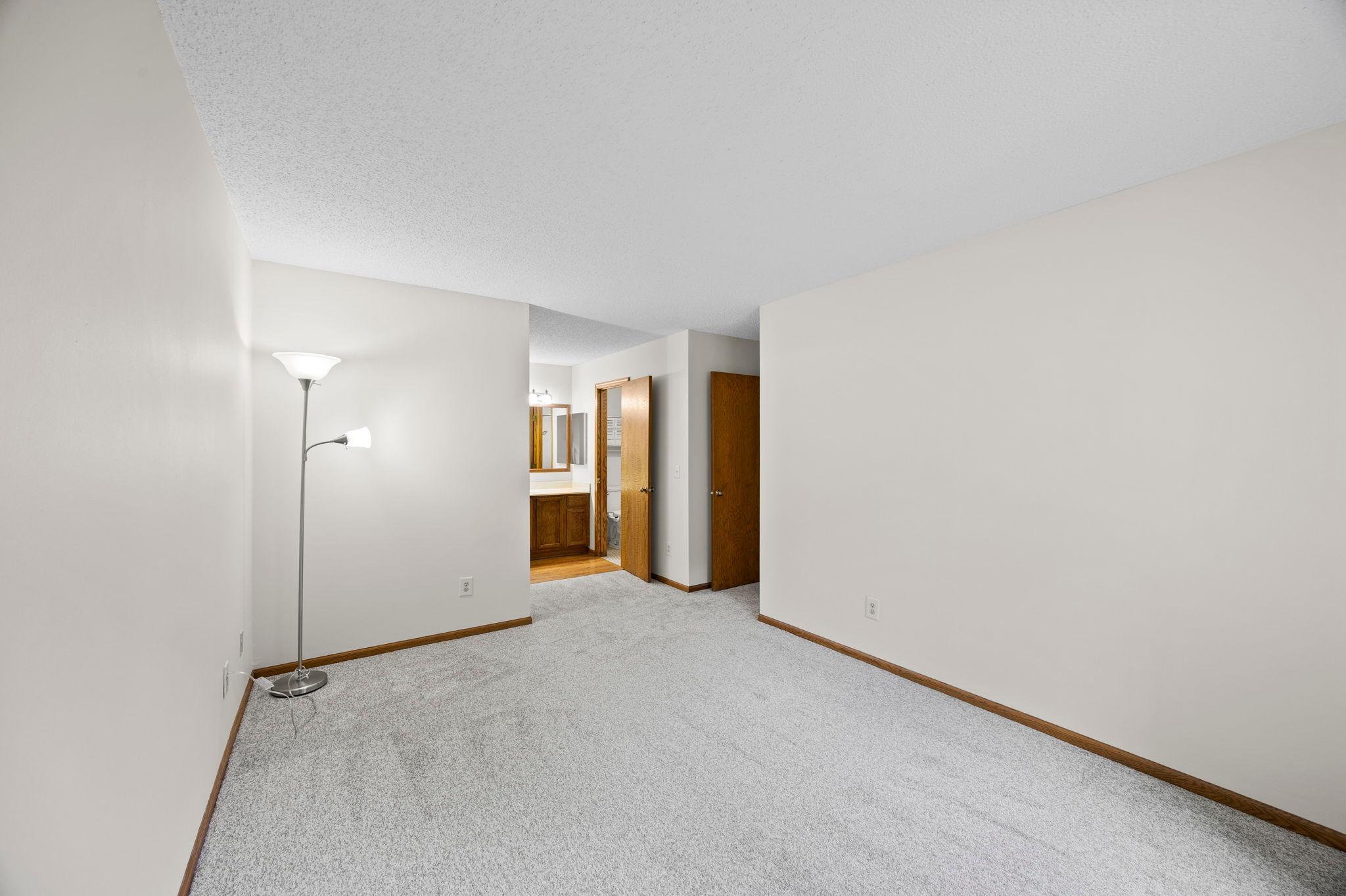 Spacious primary bedroom with its own private, bathroom.