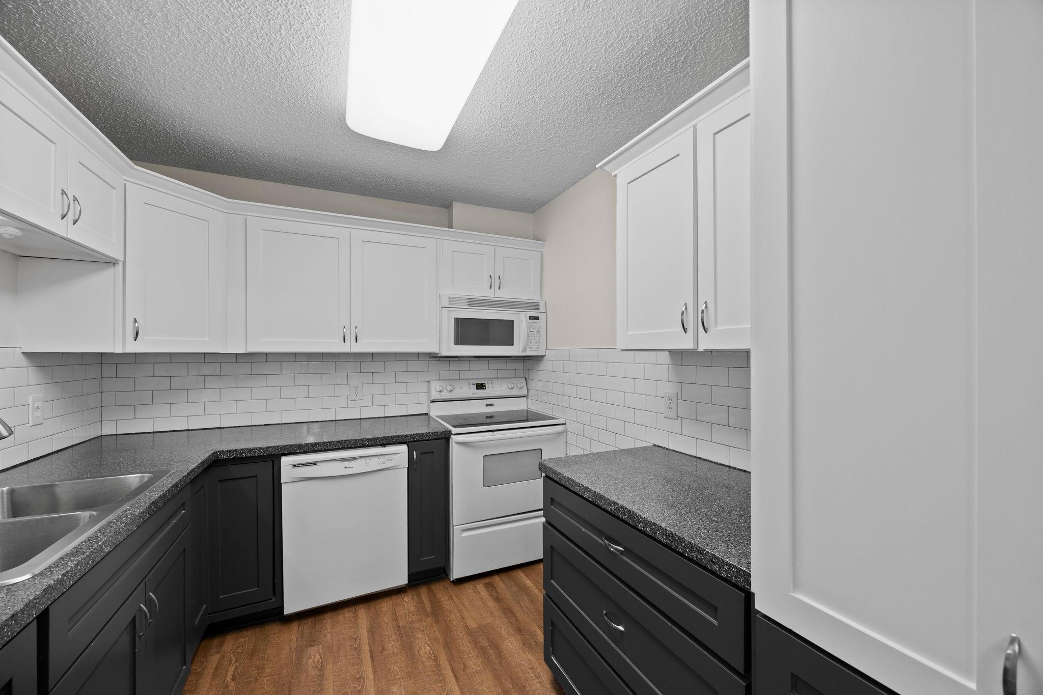 Sylish two toned cabinetry, subway tiled backsplash.