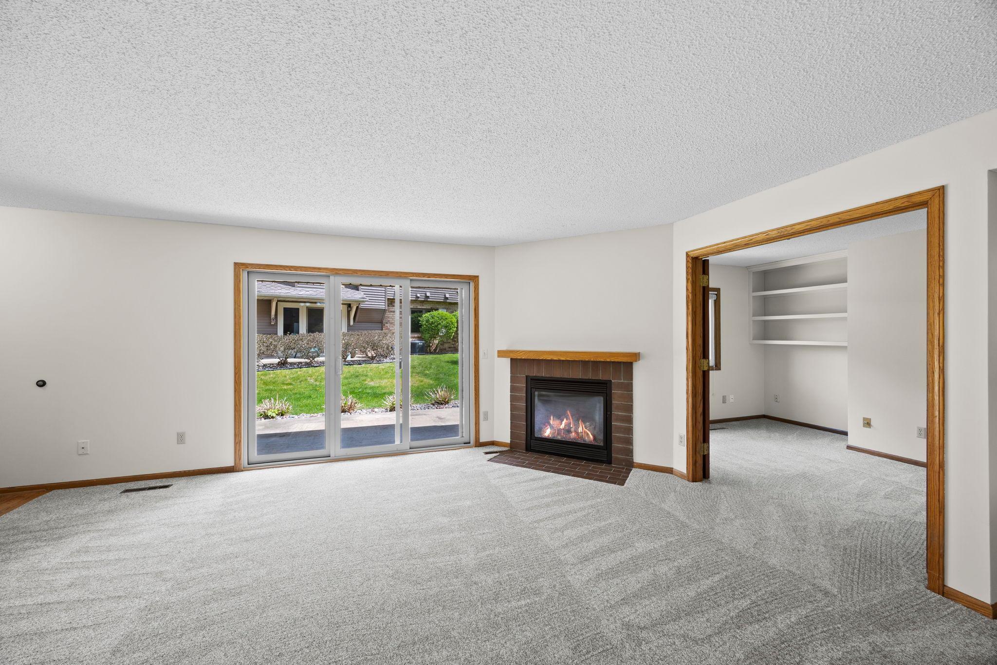Cozy, gas fireplace is the highlight of this all main level living room space.