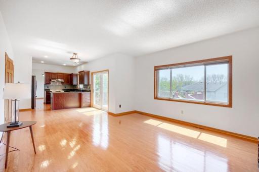 Kitchen With Open Floor Plan To Living Room and Attached Deck with Stairs