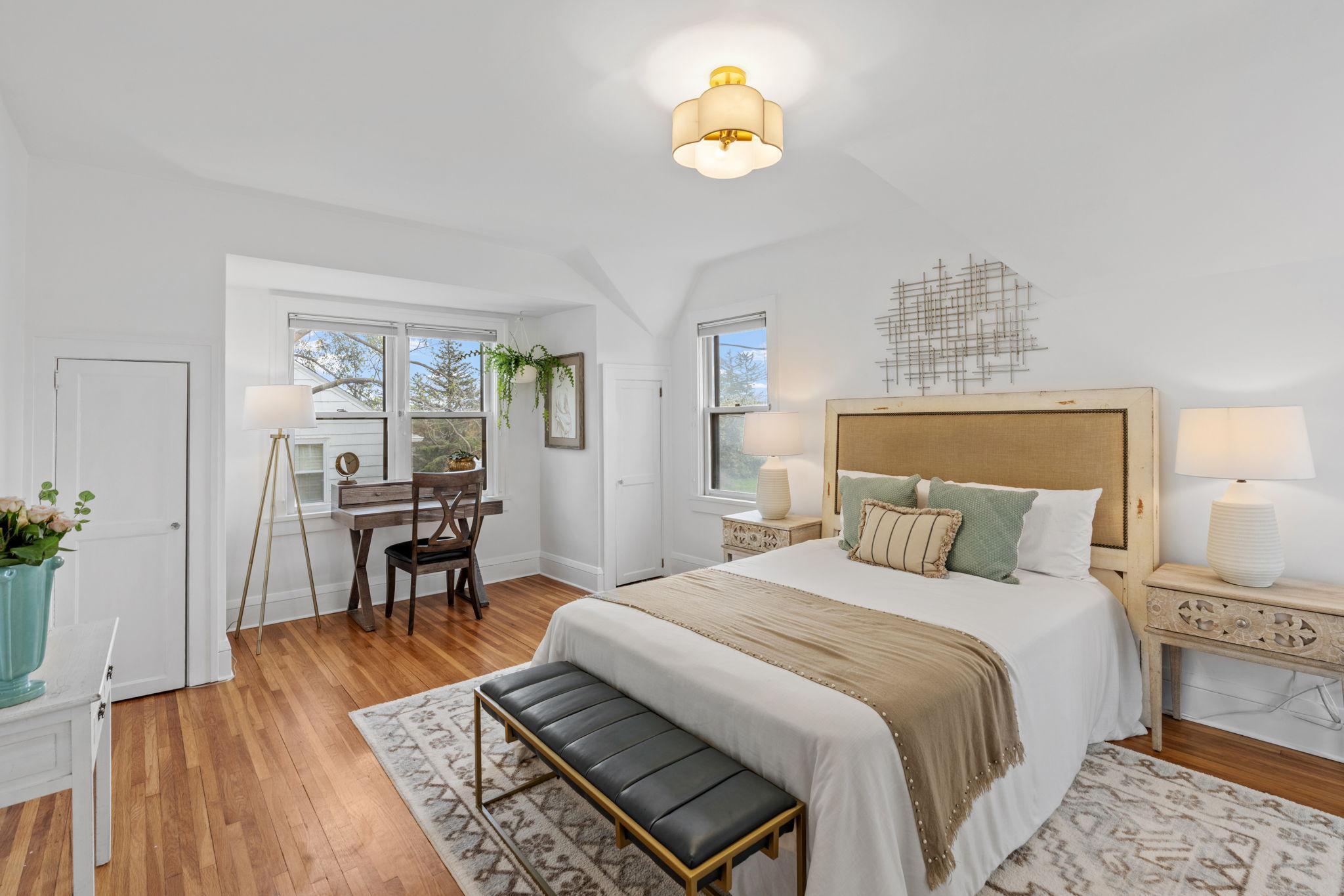 Spacious upper-level bedroom filled with natural light and beautiful hardwood floors!