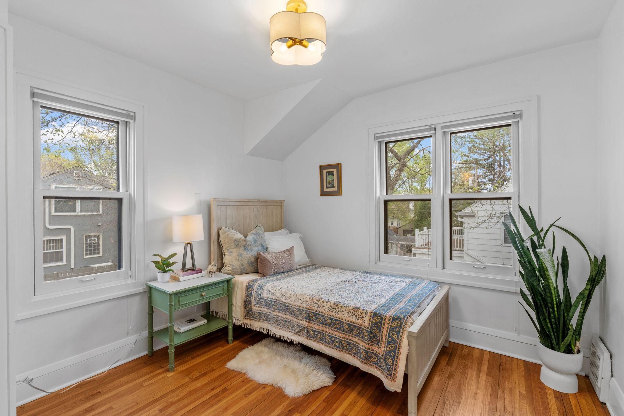 Spacious upper-level second bedroom offering a private sink and vanity for added functionality!