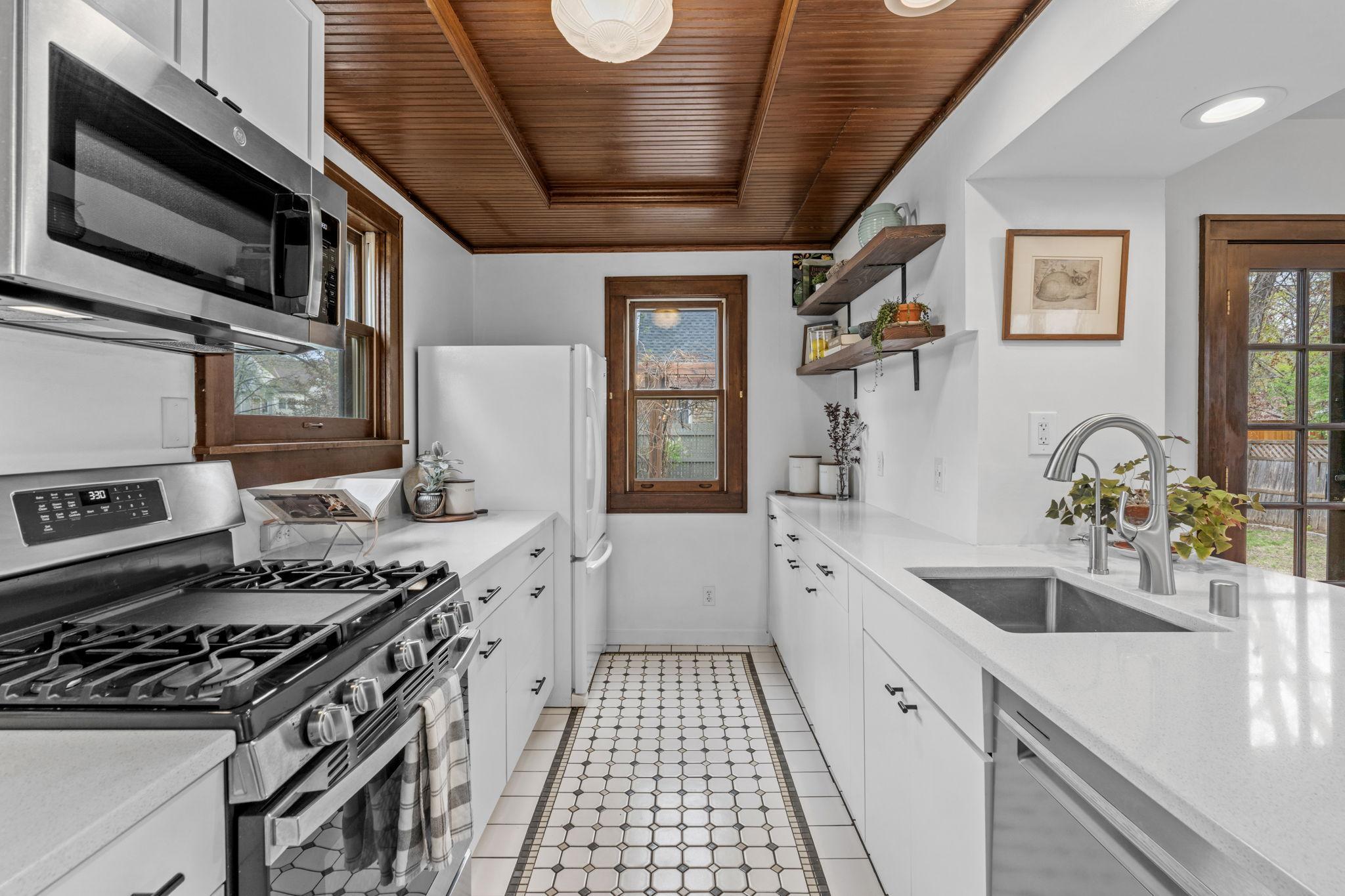 Updated kitchen blends classic charm with modern convenience, featuring new cabinetry, Silestone countertops, and stainless steel appliances!