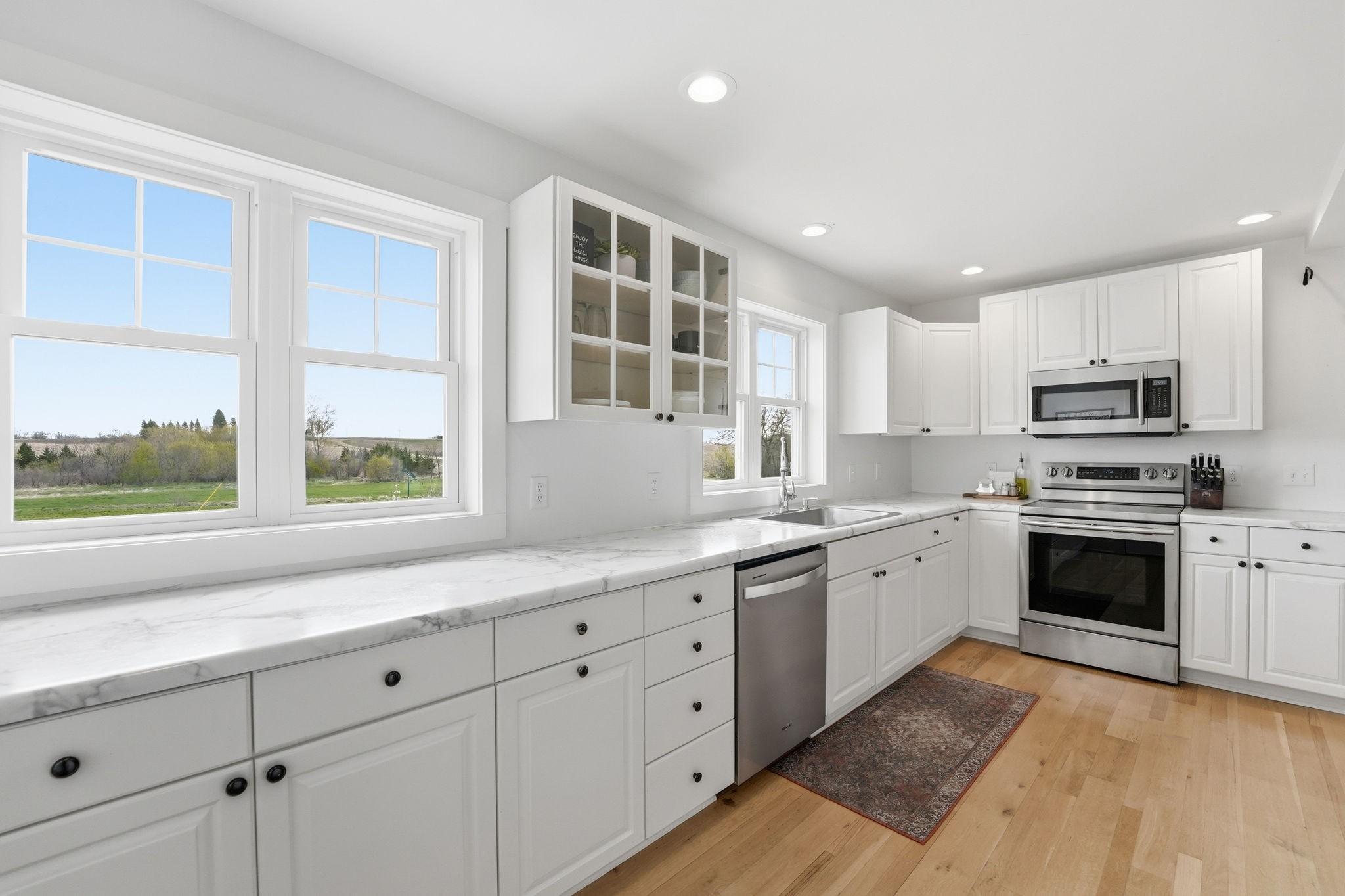 Kitchen has lots of countertop space, storage, pantry and an abundance of windows!