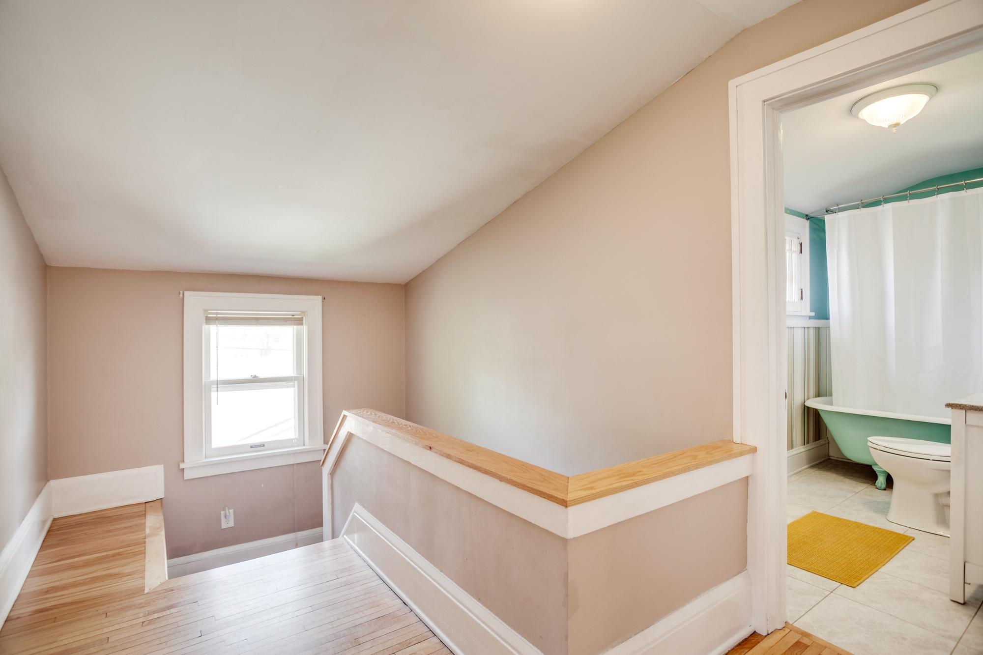 Head upstairs to find two more bedrooms and a full bathroom with clawfoot tub
