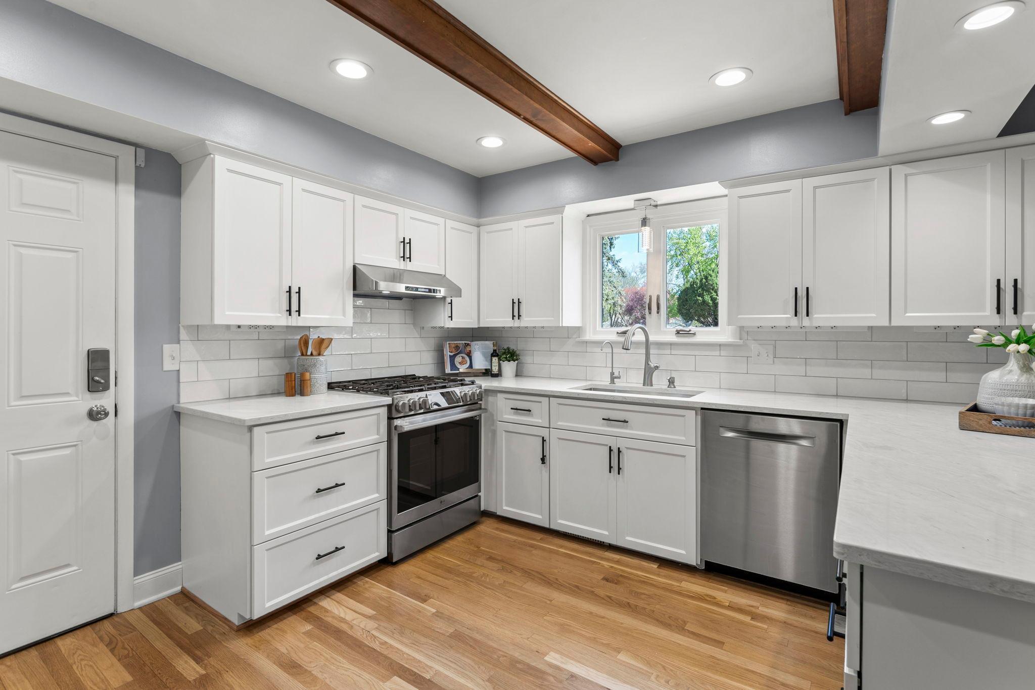 Stainless steel appliances (updated in 2024), tile backsplash, and cabinet pantry.