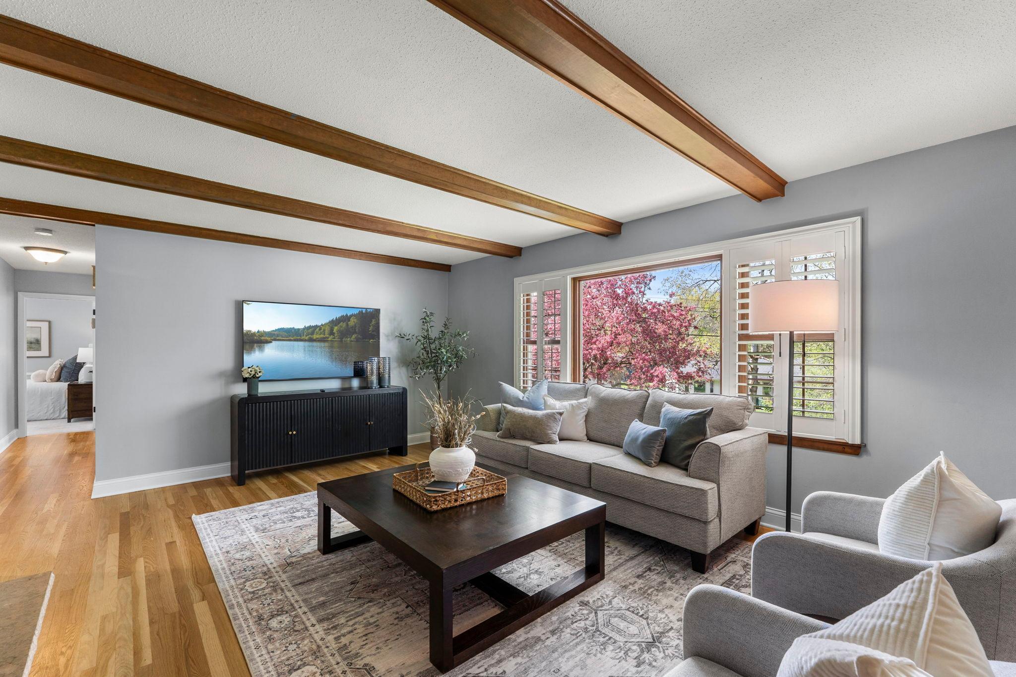 Enjoy large windows with shutters and wood beam ceiling detail.