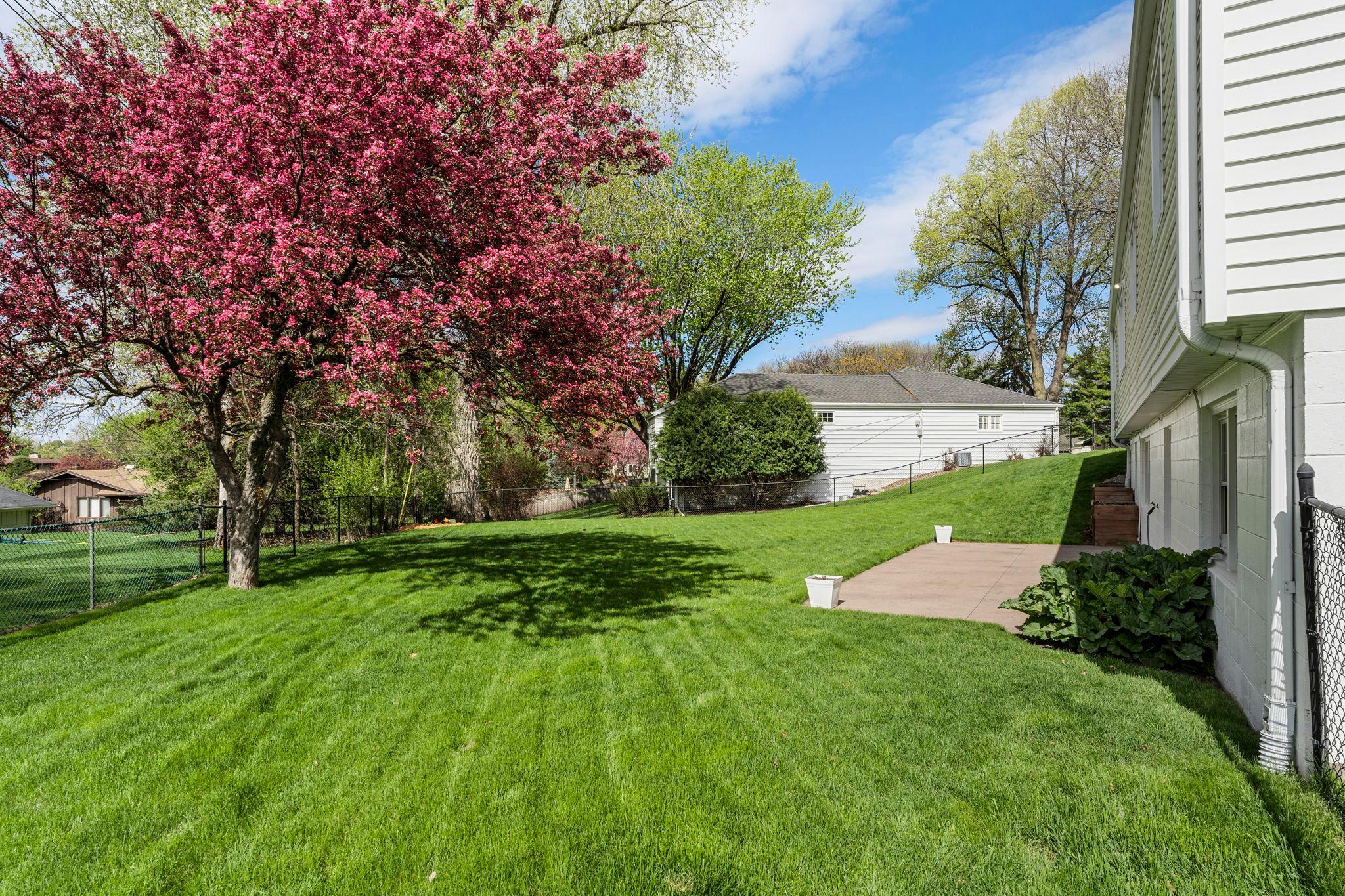 The fully fenced backyard is ideal for relaxing or entertaining. Raised flower beds, mature flowering trees in both front and back of the home, and a rhubarb bush for seasonal enjoyment!