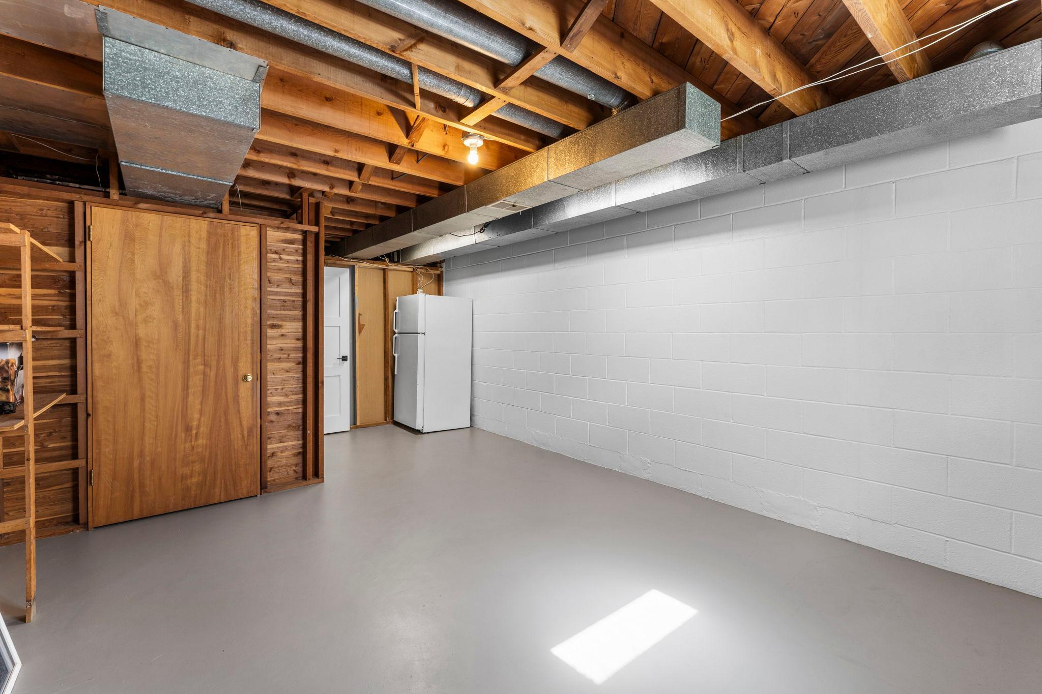 Storage is abundant throughout the lower level, including a large utility room and unfinished space ideal for storage, fitness, or future expansion.