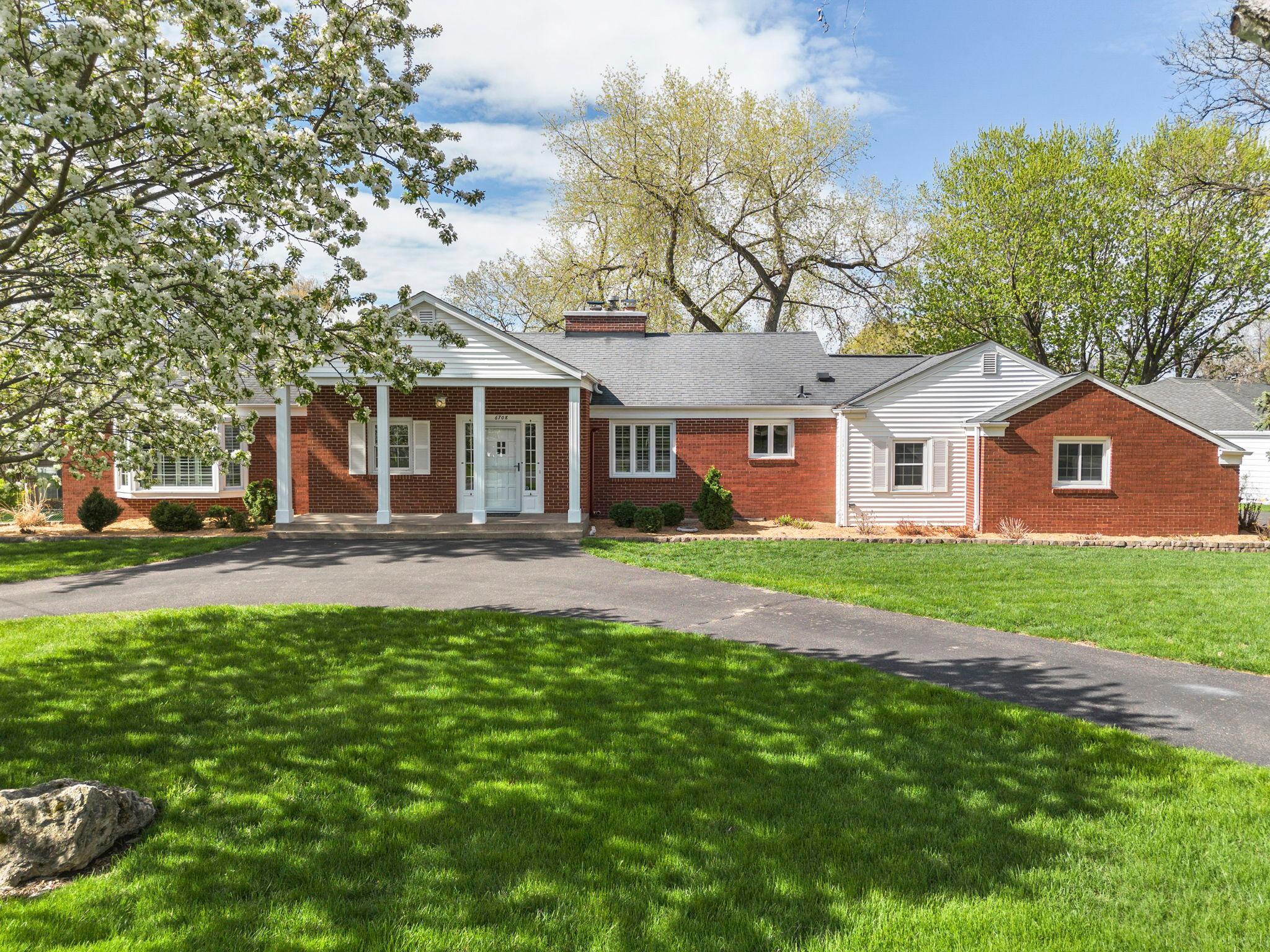 Two driveways provide exceptional off-street parking, one leading directly to the garage and a second looped driveway at the front of the home.