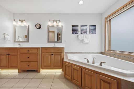 The upper-level primary bedroom is generously sized, features a spacious ensuite, and overlooks the backyard.
