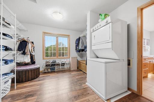 Spacious upper-level walk-in primary closet with a convenient stackable washer and dryerâmaking laundry day effortless.