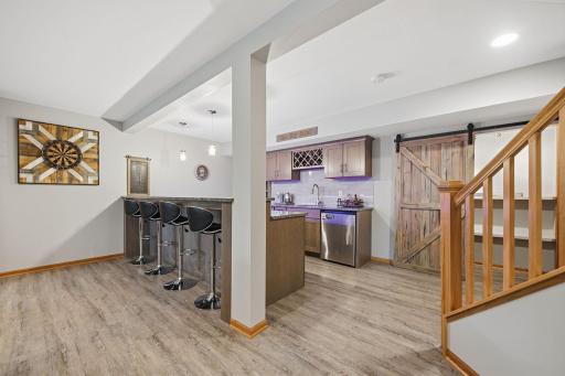 Lower level boasts high ceilings, a cozy gas fireplace, and a full barâan entertainerâs dream perfect for hosting guests or relaxing in style.