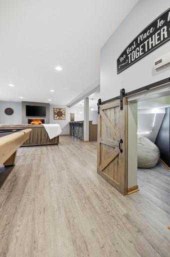 Tucked beneath the lower-level stairs is another hidden roomâperfect as a cozy reading nook, a creative space for writing on the chalk-painted walls, or a fun playtime hideaway!