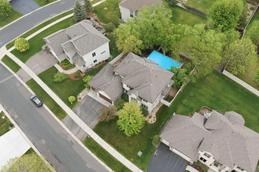 An aerial view showcases the home from above, highlighting its beautiful settingâand the wonderful neighbors that make this property truly extra special.