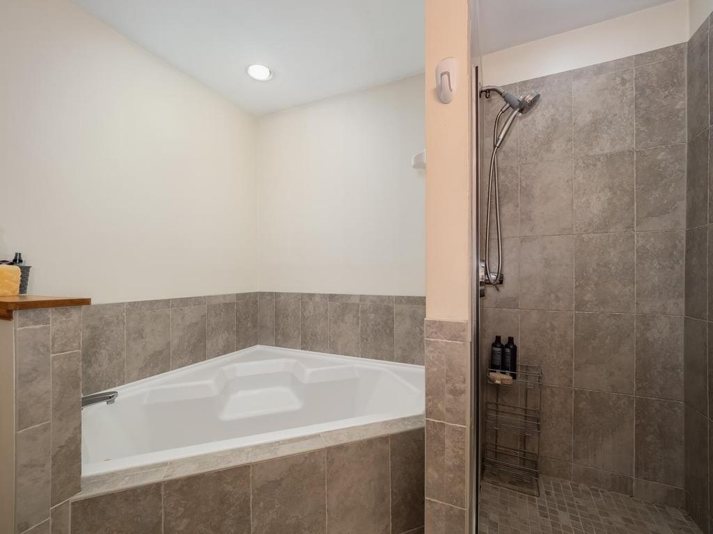 Primary full walk-thru bathroom with ceramic surround jetted tub