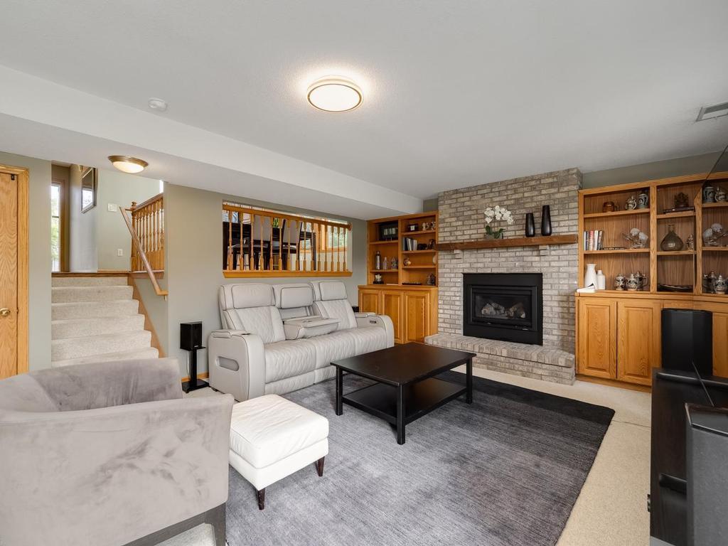Spacious lower level Family room with Gas brick fireplace flanked with book cases