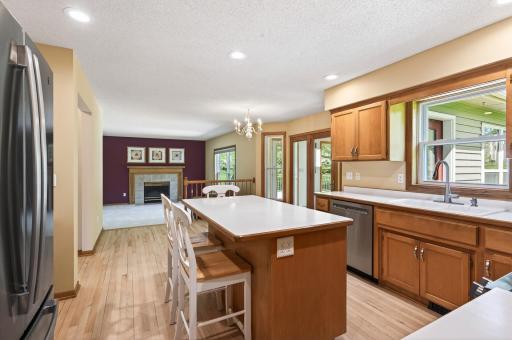 Kitchen opens up to main floor family room with gas fireplace