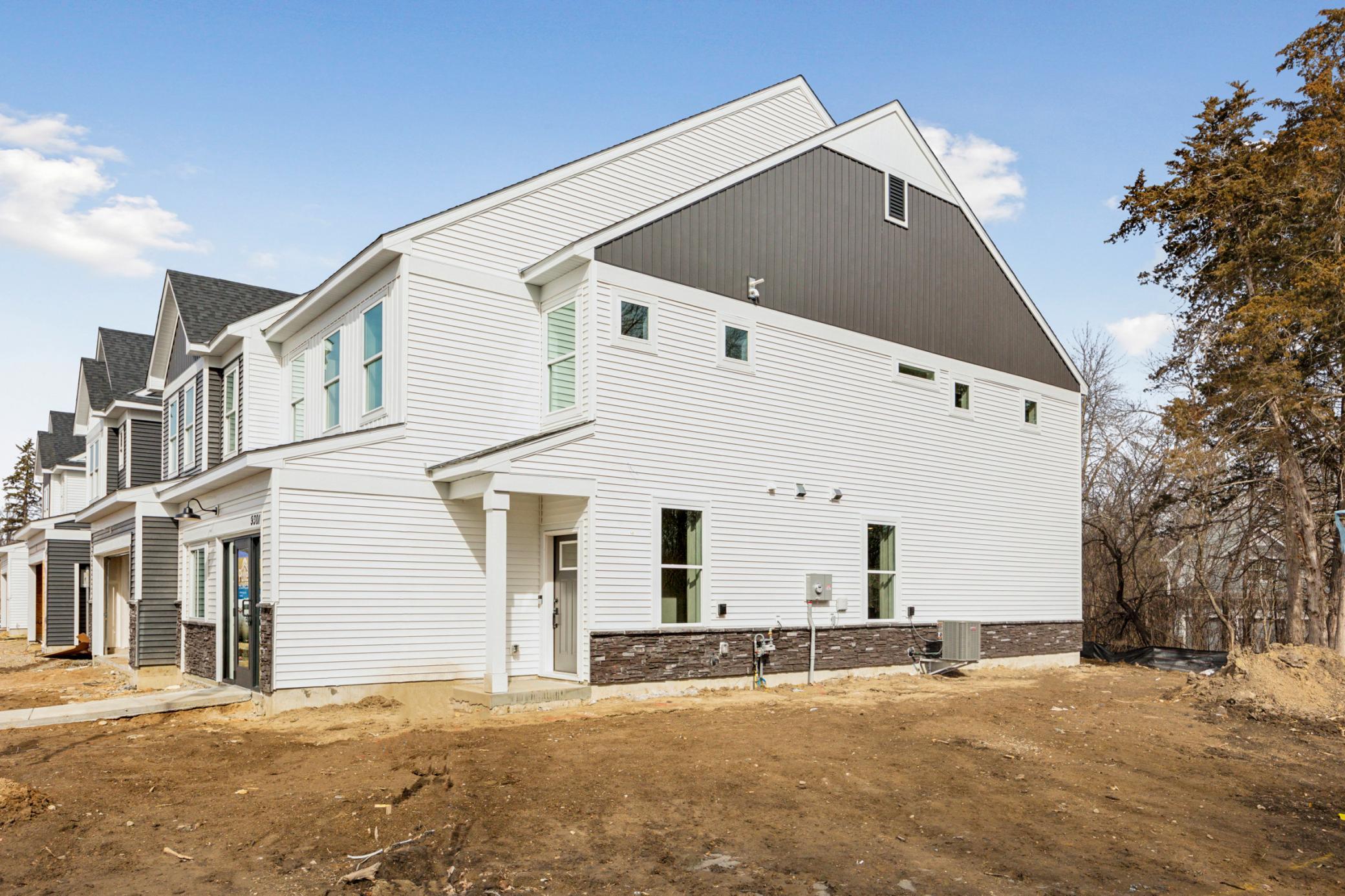 High-quality modern materials, including vinyl siding, stone accents, and contrasting trims combine to create a sophisticated and durable exterior. Pulte - 9301 Larimar Trail_Photos are of the model home. Finishes may vary.