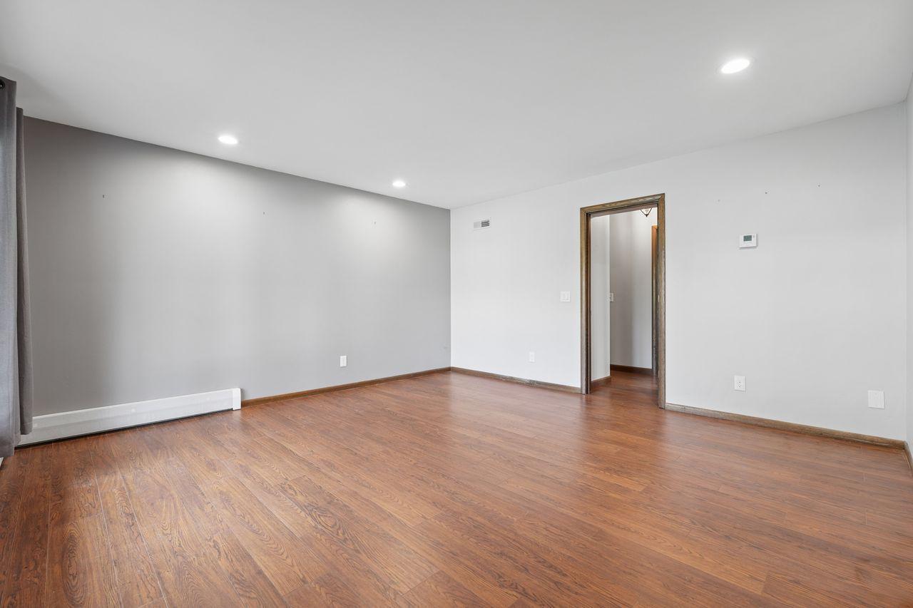 Front den off of entry, natural sunlight, neutral colors