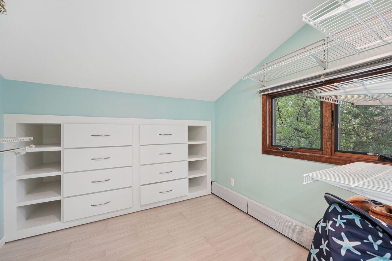 Owner suite custom walk in closet with lots of built in storage.