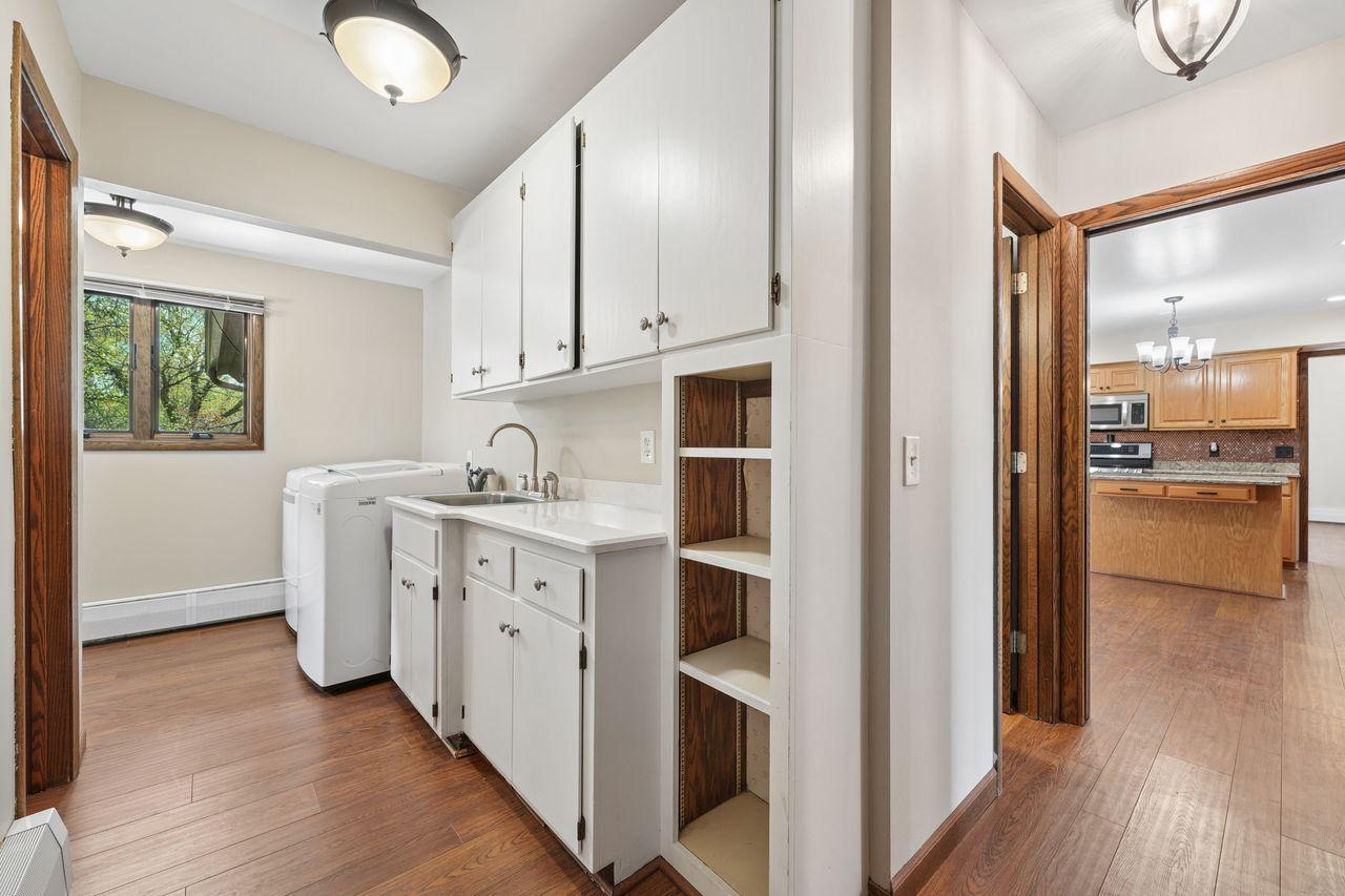 Main level laundry with newer washer & dryer, extra storage.