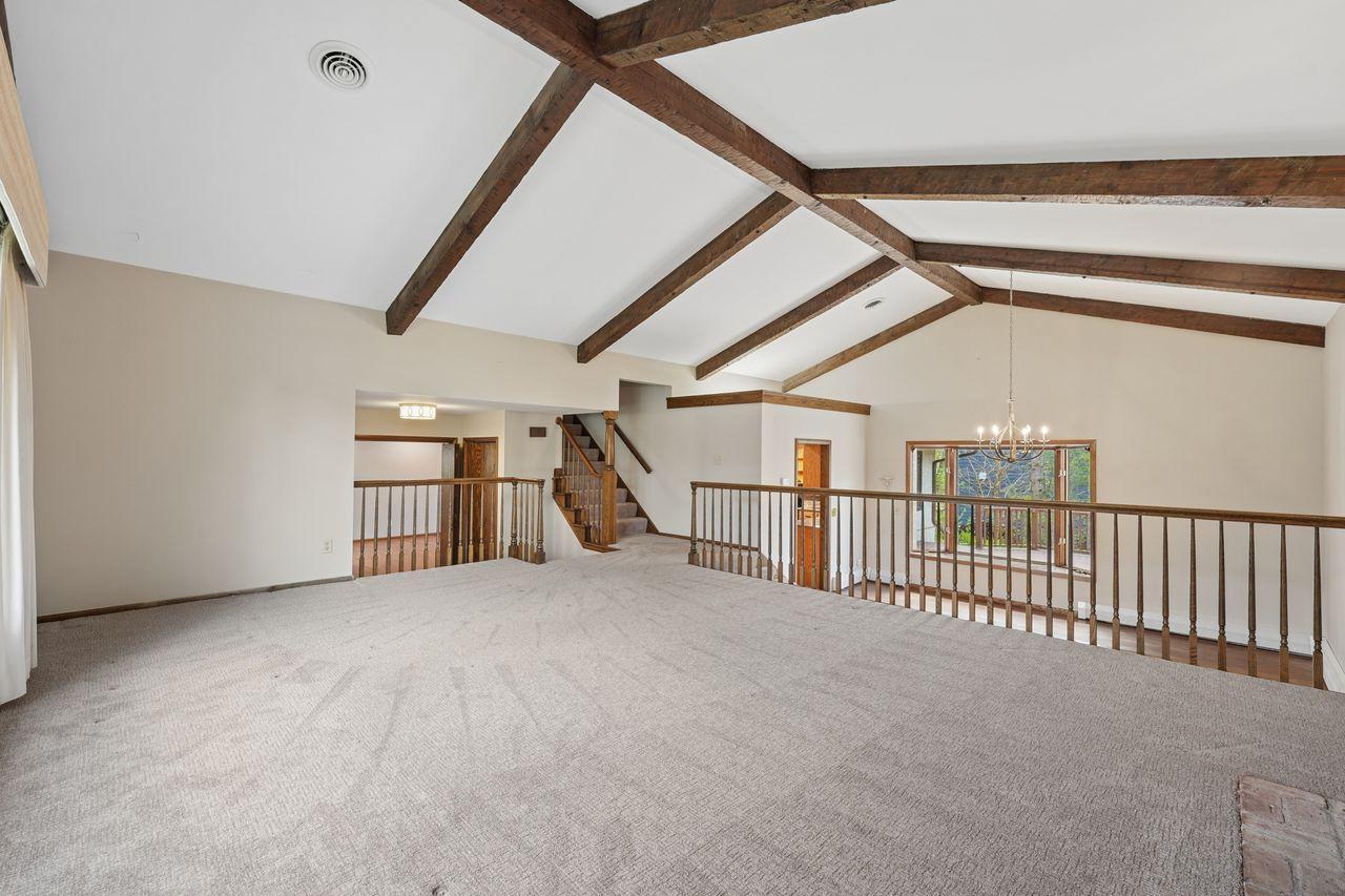 Spacious, vaulted & beamed living room, new windows throughout home (2022), lots of natural sunlight, open concept, neutral colors