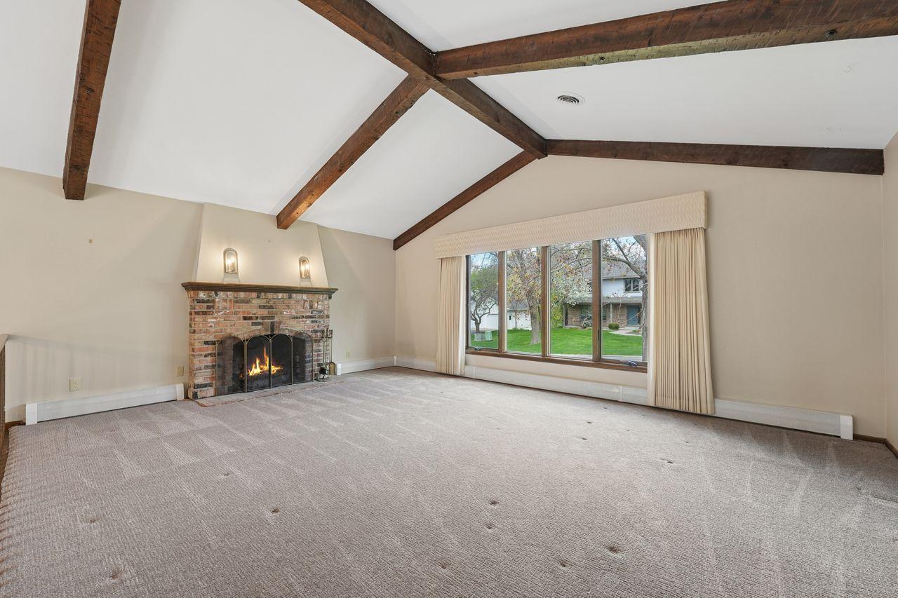 Spacious, vaulted & beamed living room, new windows throughout home (2022), lots of natural sunlight, open concept, neutral colors