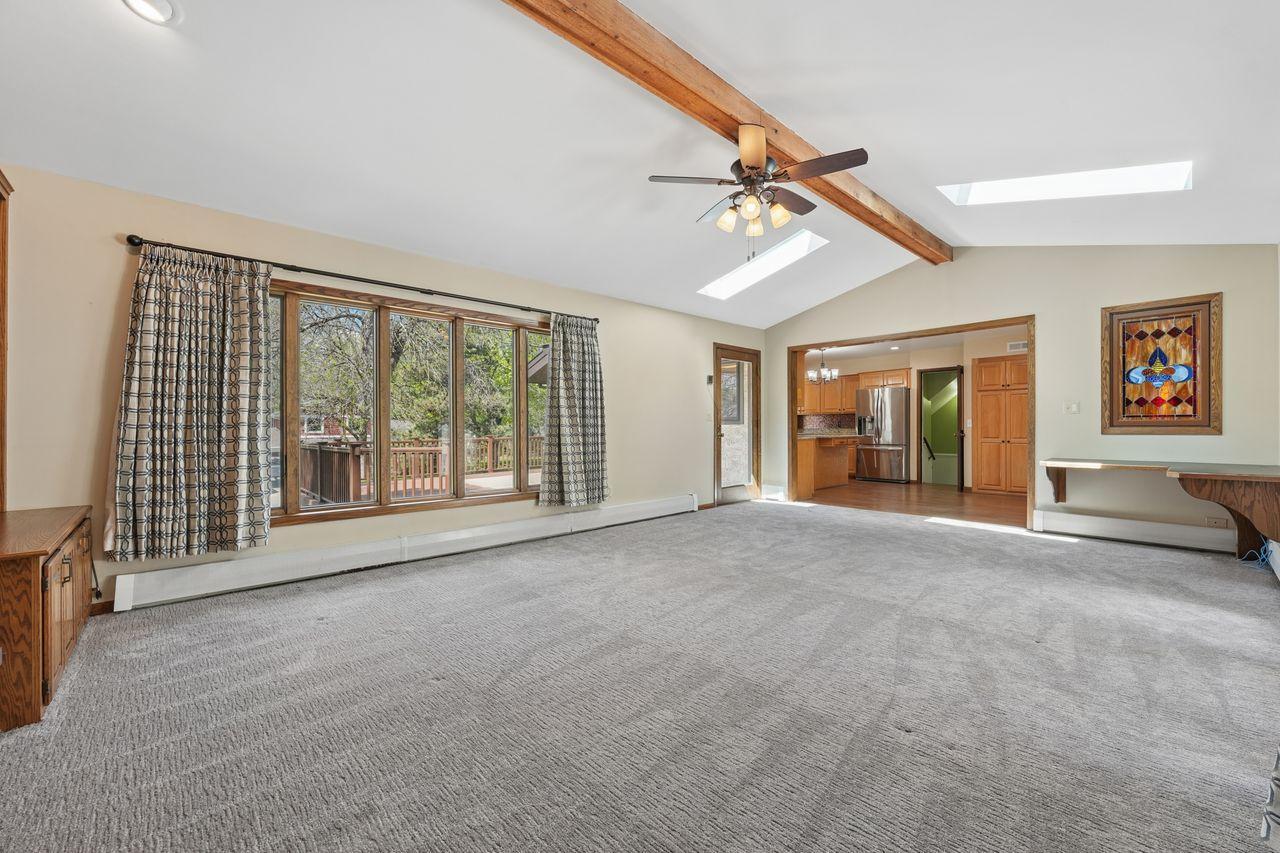 Spacious family room addition off of updated kitchen, cozy fireplace, custom built in cabinetry, doors leading out to deck, built in desk space.