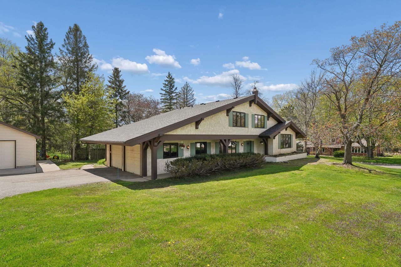 Primary front photo, spacious .5 acre lot, maintenance free stucco siding, new roof, nicely landscaped, 2 car attached garage & 2 car detached garage.