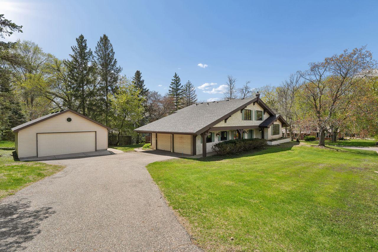 Primary front photo, spacious .5 acre lot, maintenance free stucco siding, new roof, nicely landscaped, 2 car attached garage & 2 car detached garage.