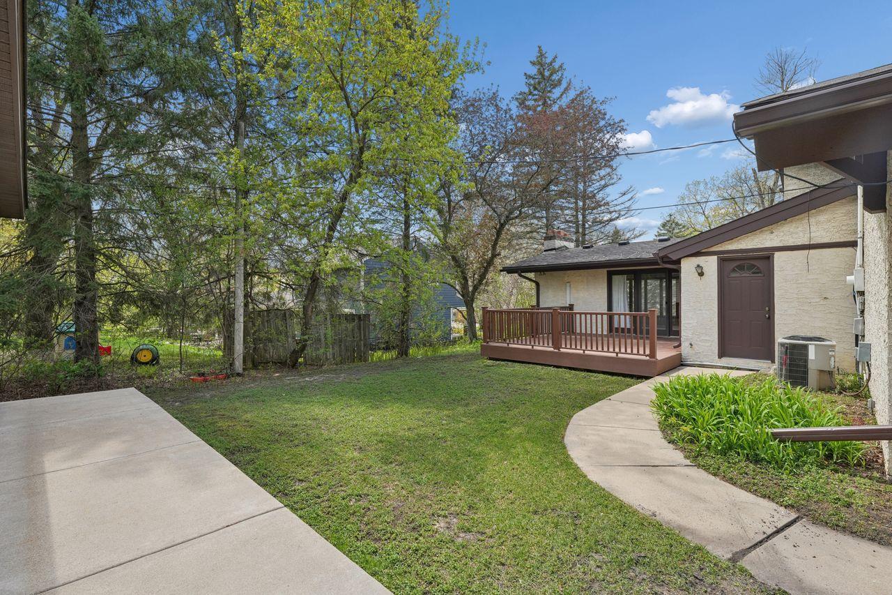 Space between garages, concrete sidewalk with access to deck and mud/laundry room.