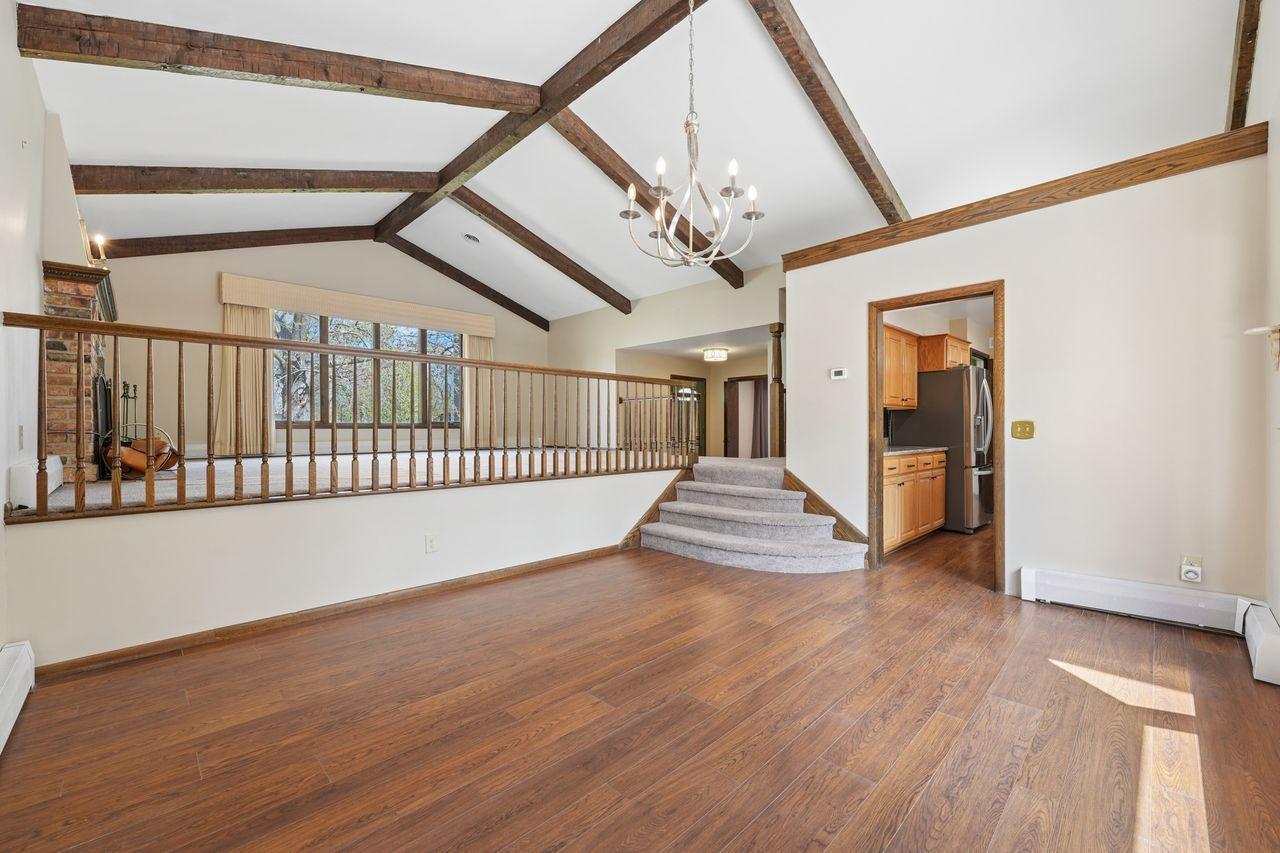 Spacious, vaulted & beamed dining area off of neighboring kitchen