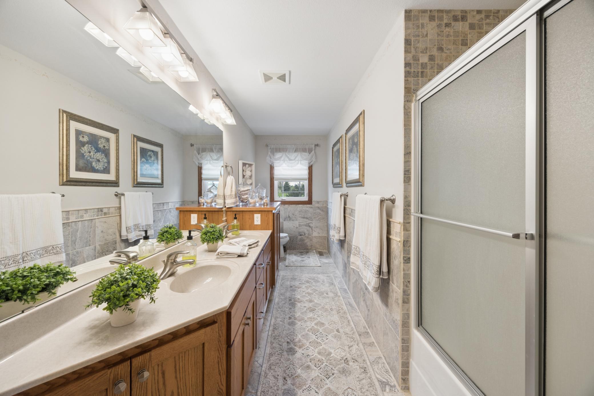 Convenient upper level full bath featuring a double vanity.