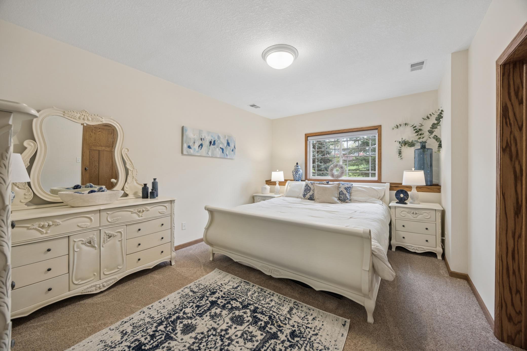 Lower level fourth bedroom featuring abundant natural light.