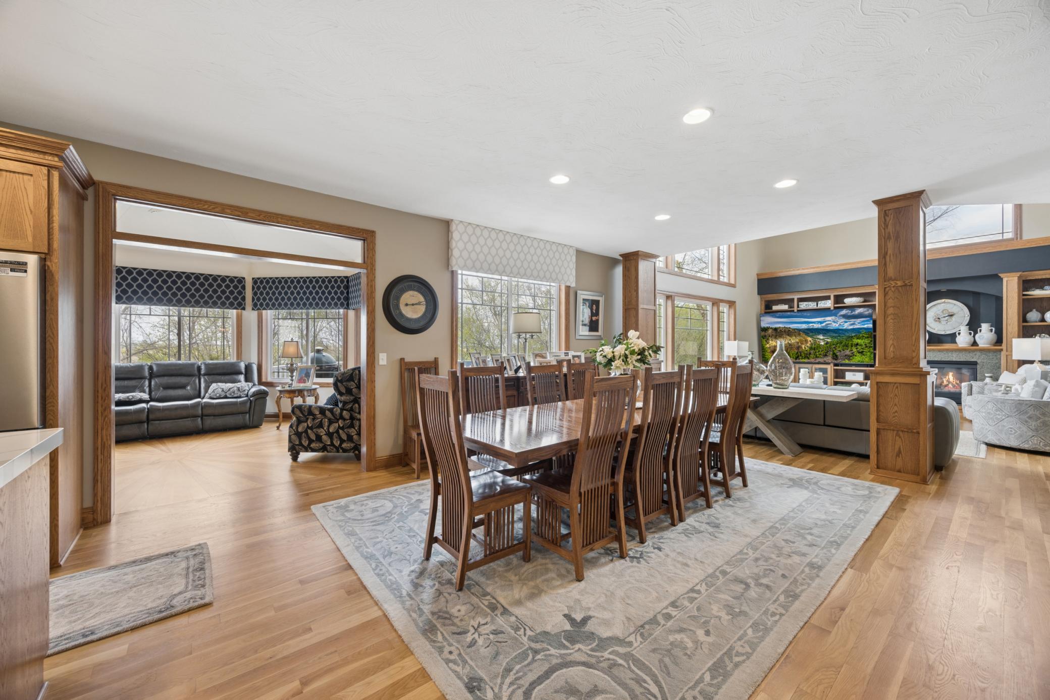 Expansive informal dining space with seamless views into the kitchen, sunroom, and living room.