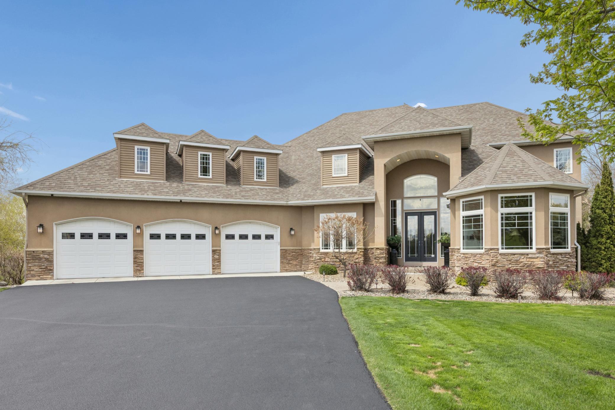 Stunning executive two-story, showcasing timeless curb appeal, beautifully maintained exterior for a grand first impression.