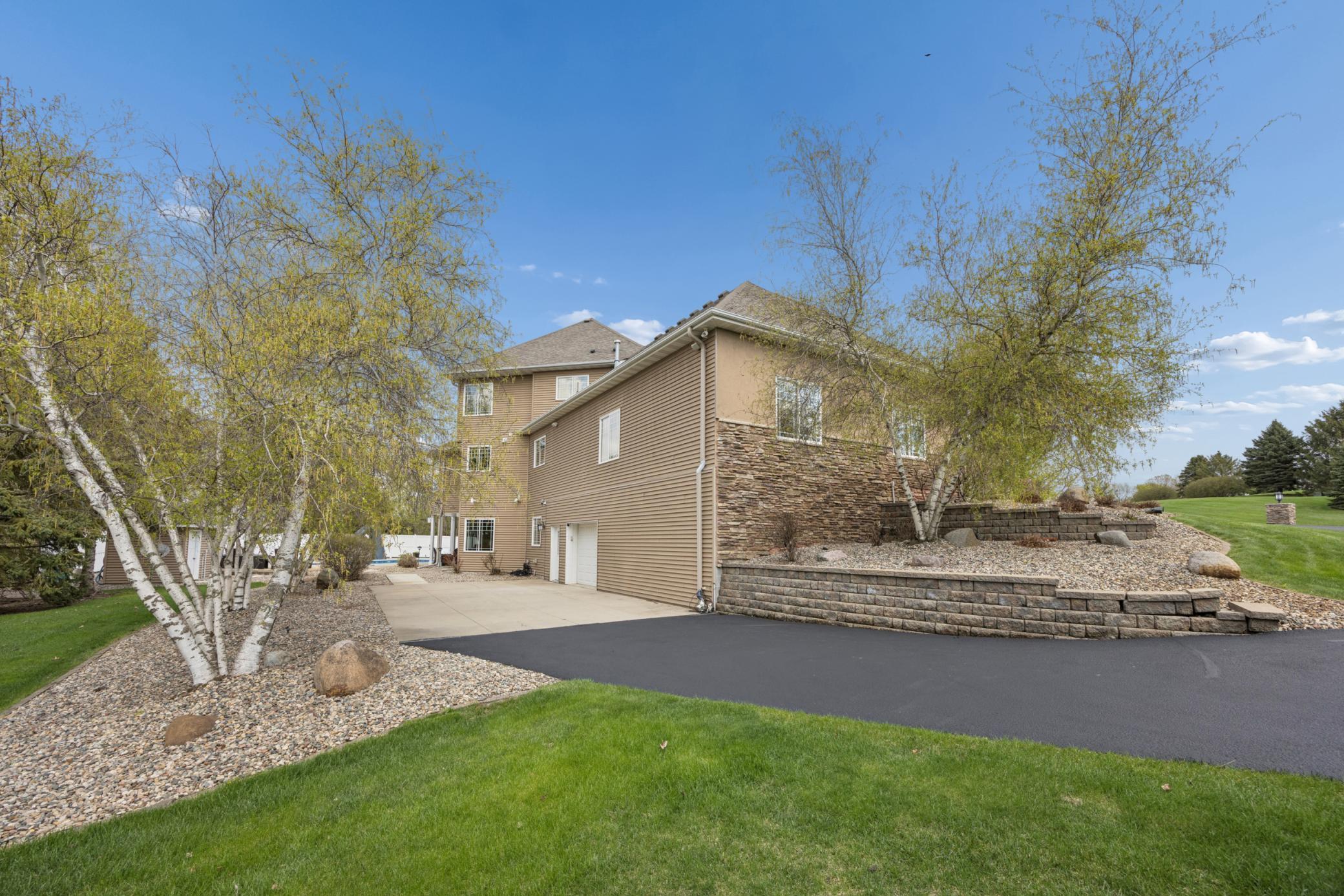 Paved driveway leading to spancrete garage.