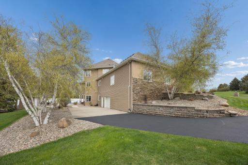 Paved driveway leading to spancrete garage.