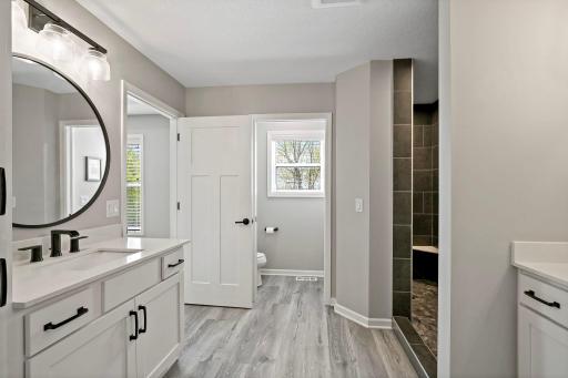 Primary bathroom features dual sinks and separate vanities