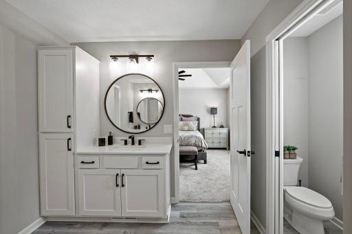 Primary bathroom features dual sinks and separate vanities