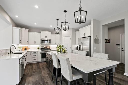 Kitchen highlights include SS appliances, oversized kitchen island with barstool seating, and a walk-in pantry