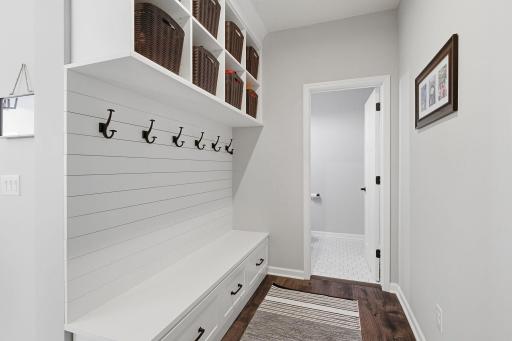 Great entryway from the garage with bench and organizational components