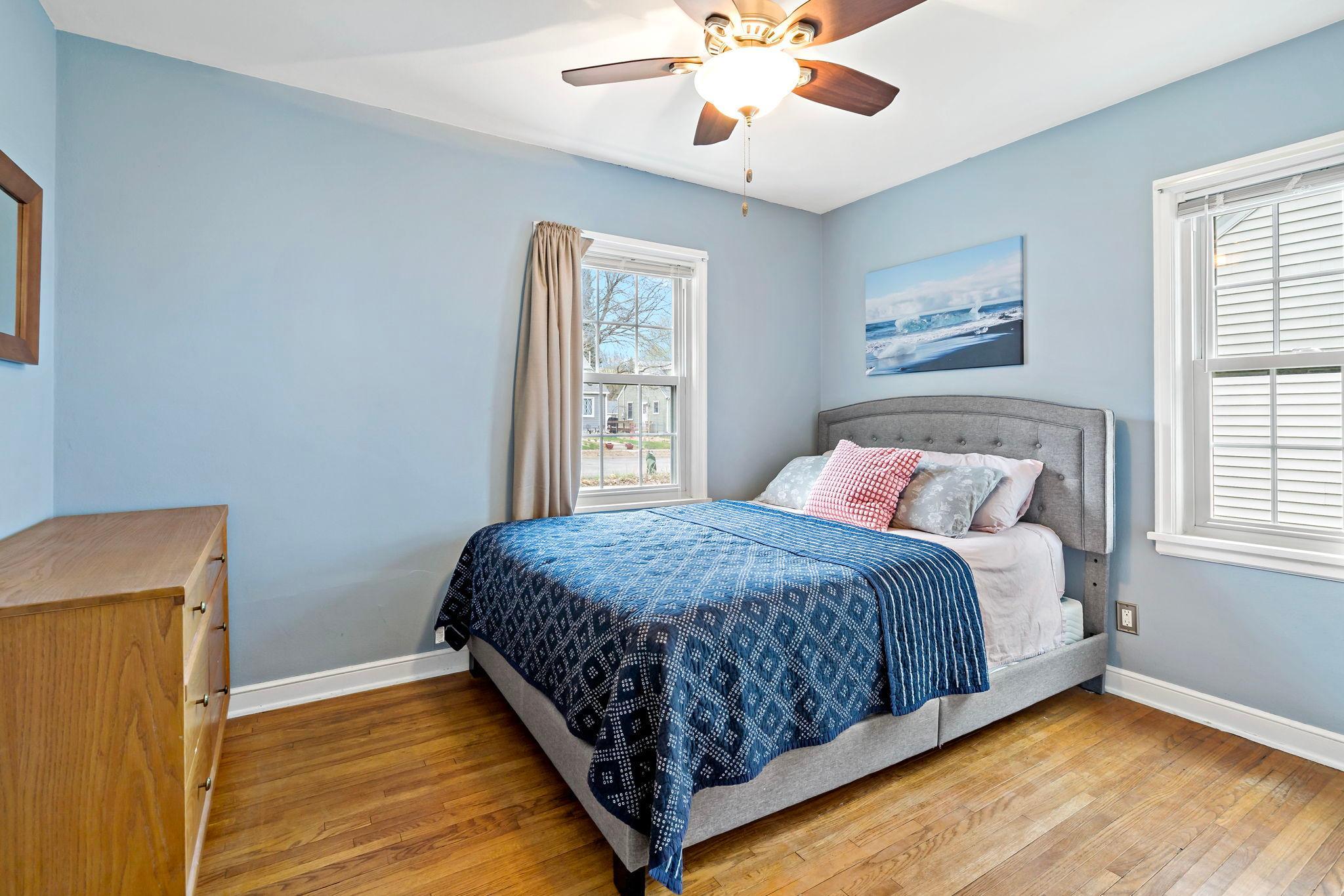 Bedroom one features updated midcentury corner windows and a big closet.