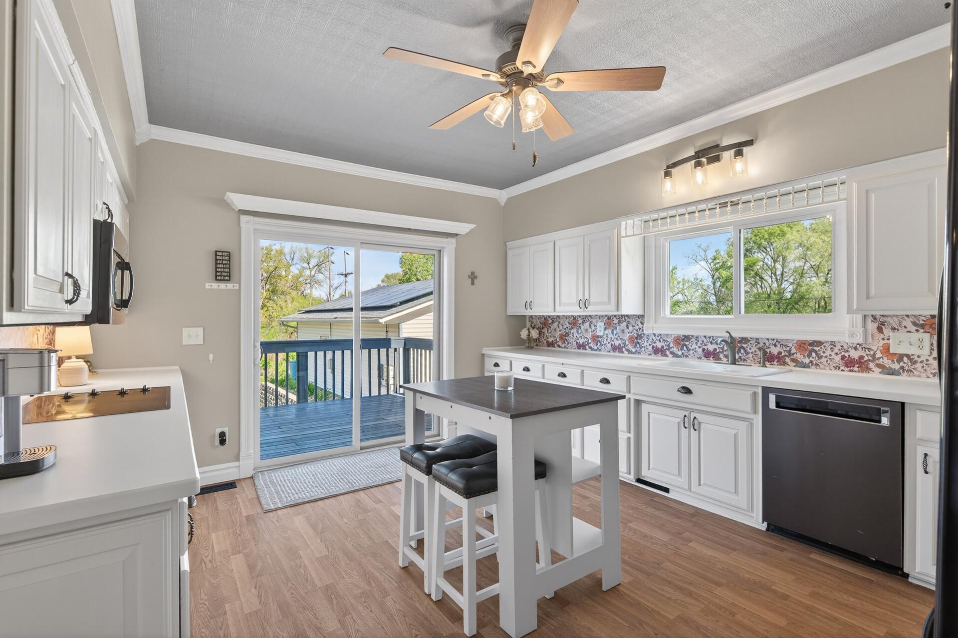Kitchen has large sliding glass door off to the back deck