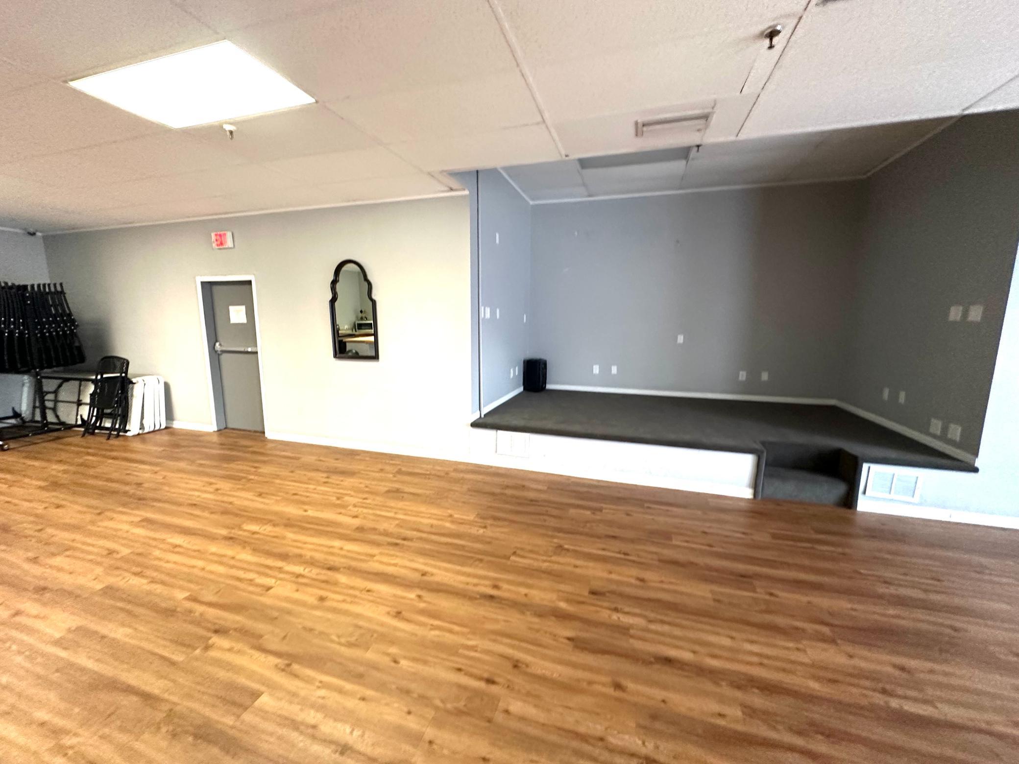 Party Room has tables, chairs, a kitchenette, a stage