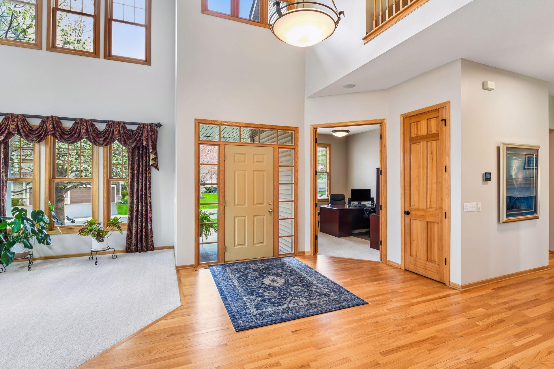 The vaulted foyer sets the tone with a grand, light-filled entrance.