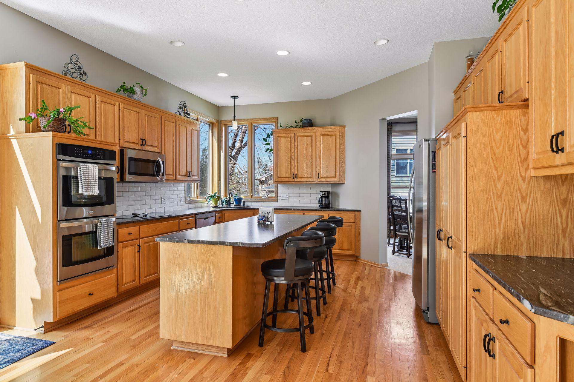 The kitchen sink is perfectly placed beneath large lookout windows, bringing in abundant natural light.