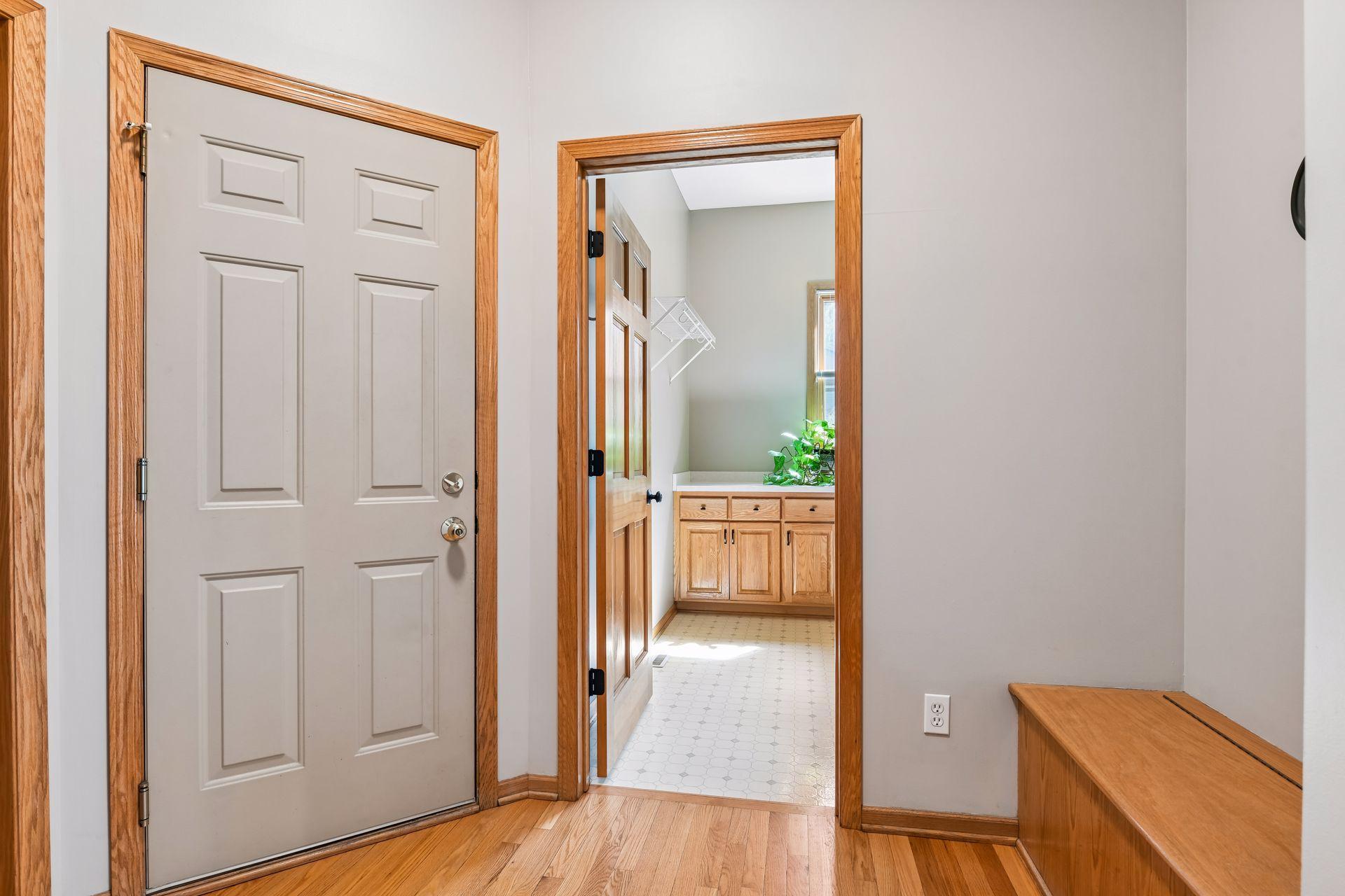 Main level mudroom with large walk-in closet leading into the main level laundry room