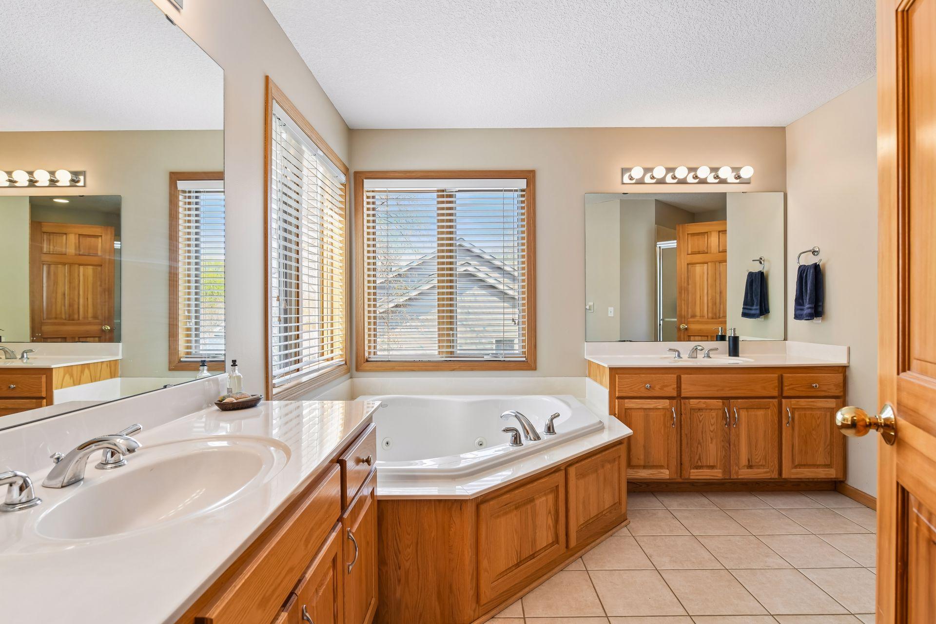 The primary bath offers dual vanities and a relaxing soaker tub.